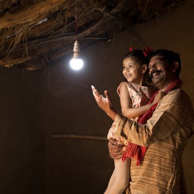 Rural,Indian,Father,With,Daughter,Delighted,On,Electricity,Reaching,Their