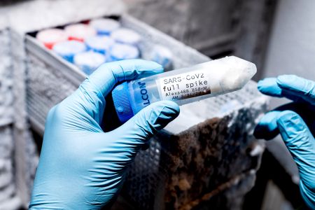 A UCSF researcher examines a tube of purified spike protein from the SARS-COV-2 virus in the lab of Aashish Manglik, MD, PhD on Thursday, July 30, 2020, at UCSF’s Mission Bay campus. The lab has created the foundation for an inhalable “biological PPE” that could guard against SARS-COV-2. (Photo by Noah Berger)..